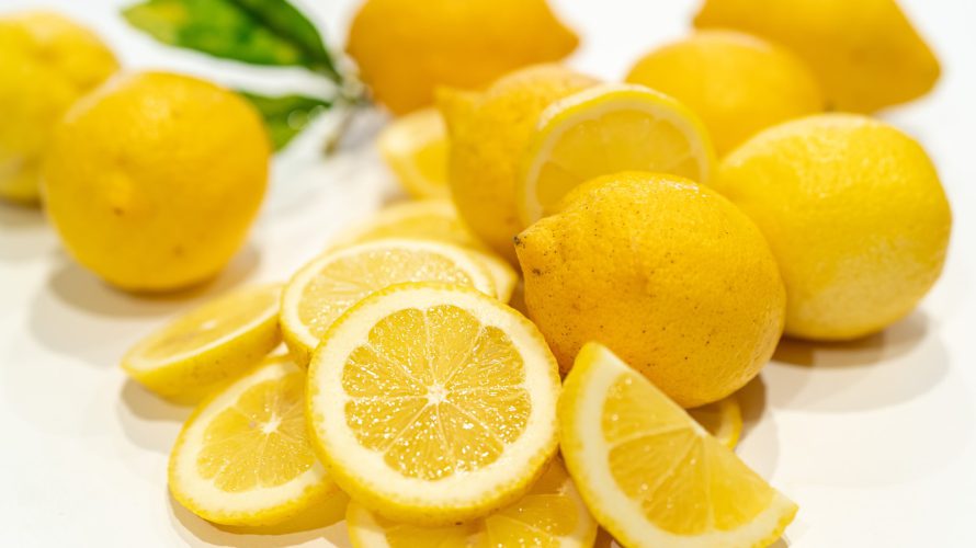 yellow lemon fruits on white surface